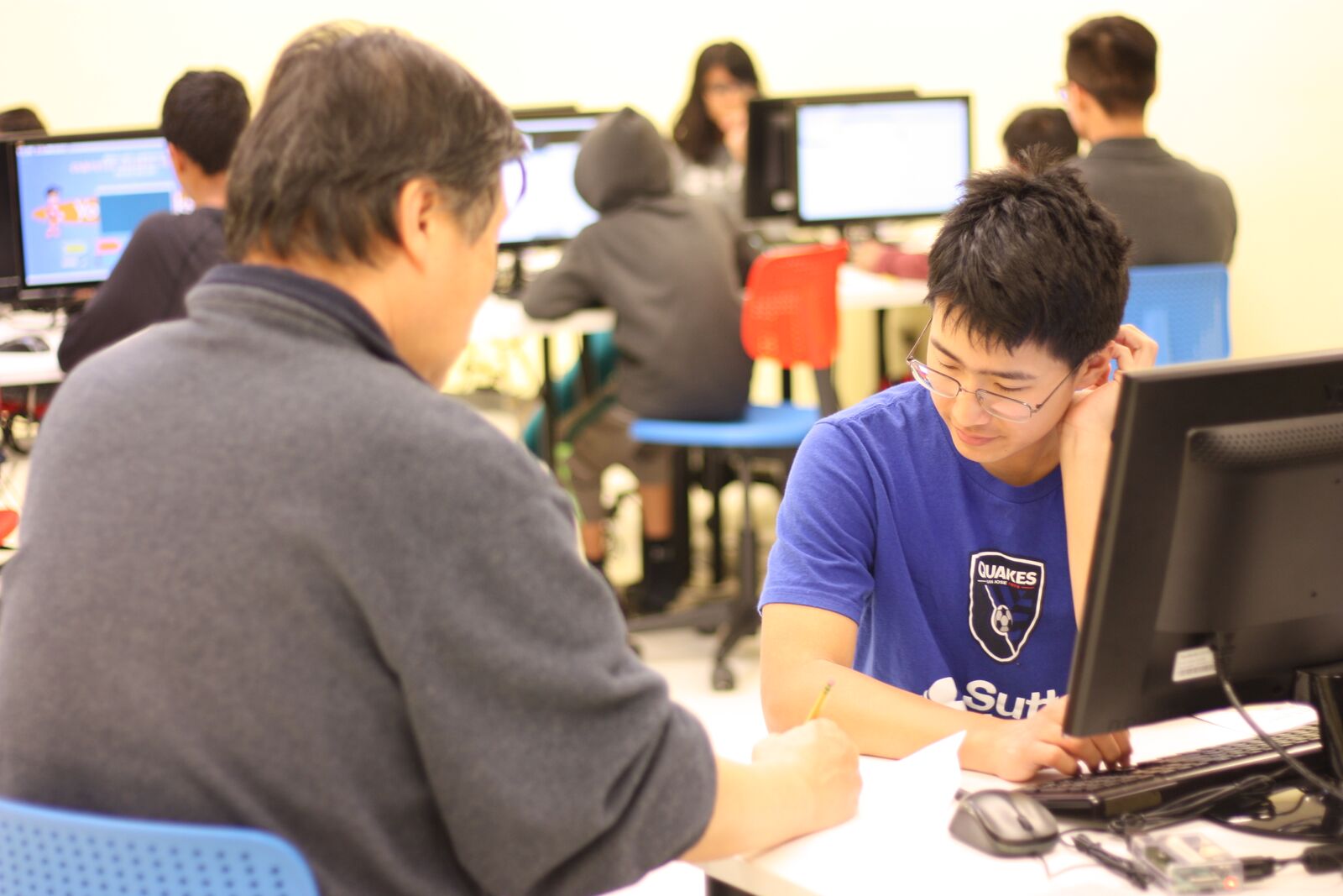 An experienced instructor explaining complex algorithms to a student in a simplified manner.