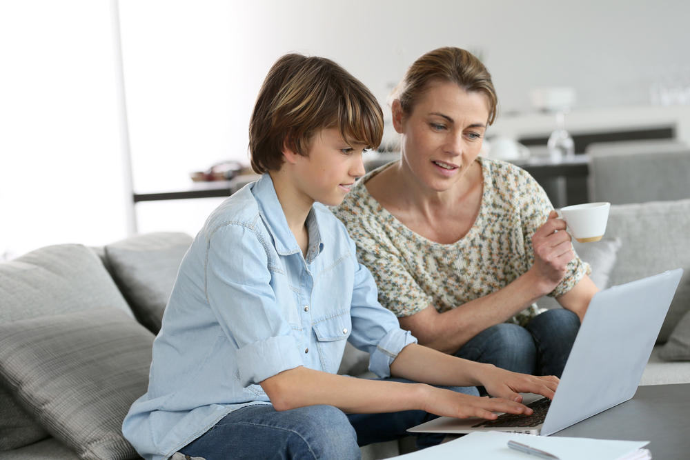 A mother helping her kid do the homework to improve their academic performance
