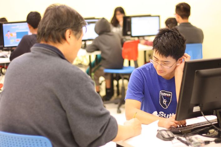 An experienced instructor explaining complex algorithms to a student in a simplified manner.